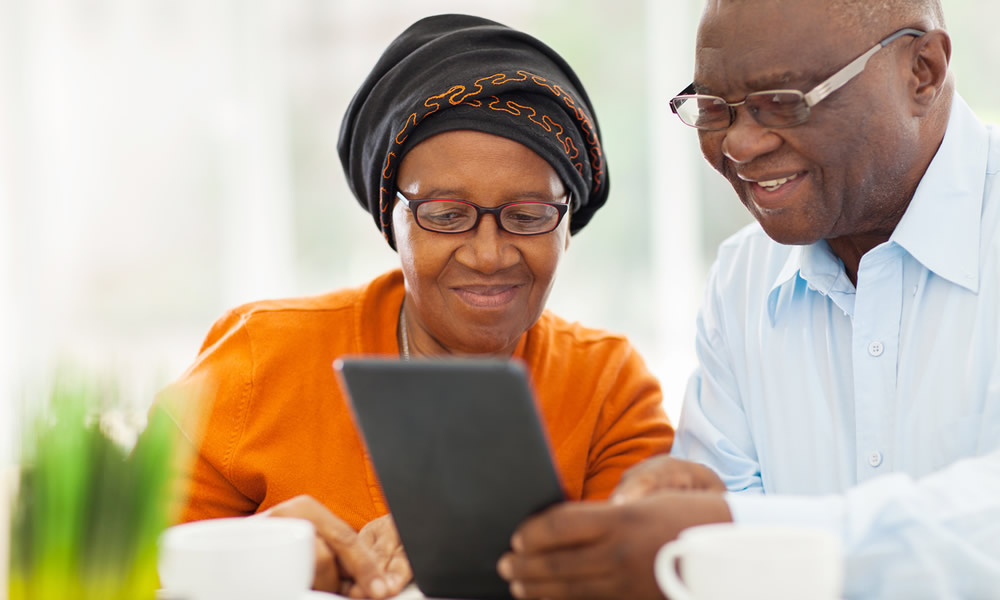 Elderly african couple using tablet computer